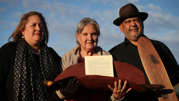 Megan Davis, Pat Anderson and Noel Pearson with a piti holding the Uluru Statement from the Heart in May 2017.