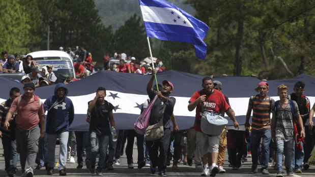 Hondurans march in a caravan of migrants moving toward the country's border with Guatemala. 