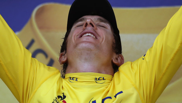 Relief and joy: Welshman Geraint Thomas, wearing the overall leader's yellow jersey, celebrates on the podium after the 20th stage of the Tour de France.