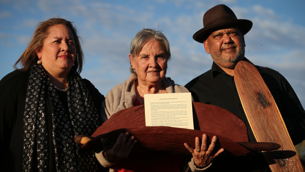 Megan Davis, Pat Anderson and Noel Pearson with a piti holding the Uluru Statement from the Heart.
