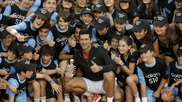 'Cringe-worthy': Novak Djokovic with the ball kids after winning the Madrid Open. Kyrgios isn't his biggest fan.