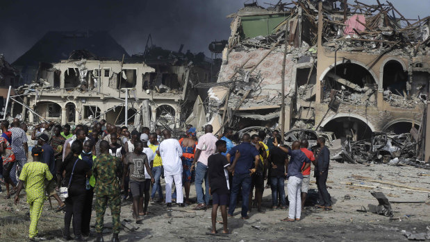 People gather near the site of an explosion in Lagos, Nigeria.