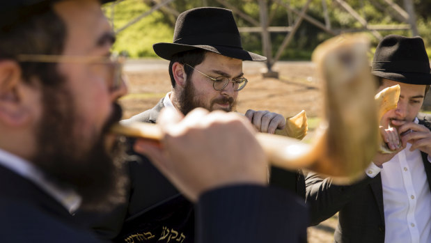 Members of the Jewish community blow on shofars during the ceremony at Rookwood Cemetery.