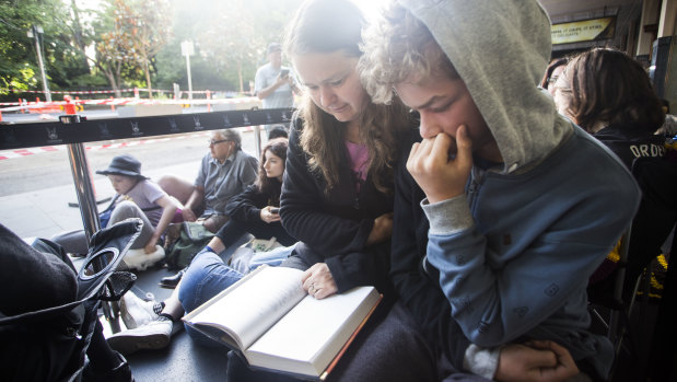 The best way to pass the time: These fans read a Harry Potter book while waiting for tickets.