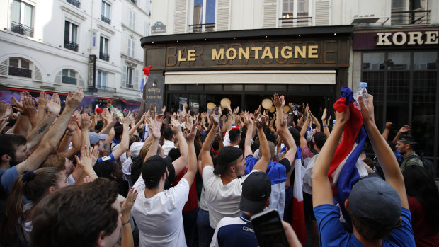 French fans react as they watch the final in a Parisian cafe.