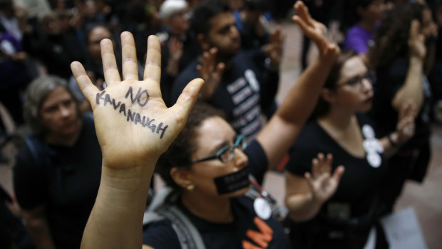 Protesters gather inside the senate hearing featuring Christine Blasey Ford.