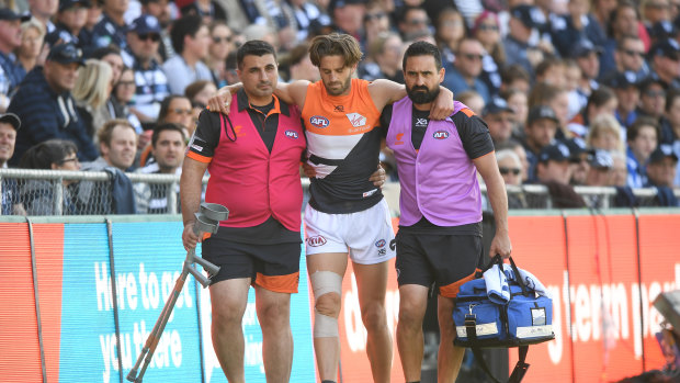 Callan Ward is helped off the field last Saturday.