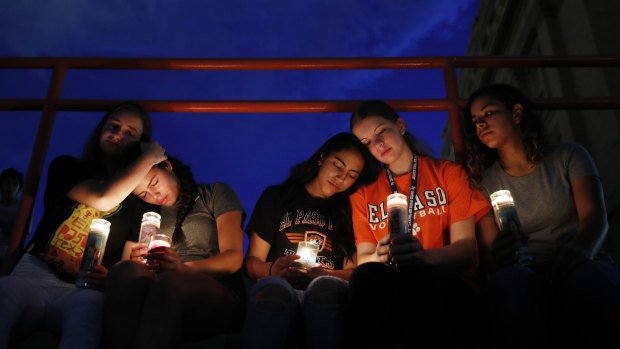 From left, Melody Stout, Hannah Payan, Aaliyah Alba, Sherie Gramlich and Laura Barrios comfort each other during a vigil for victims of the shooting on Saturday.