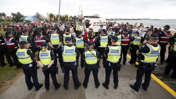 Police stand between far-right and anti-racism protesters at a rally in Melbourne in January this year.