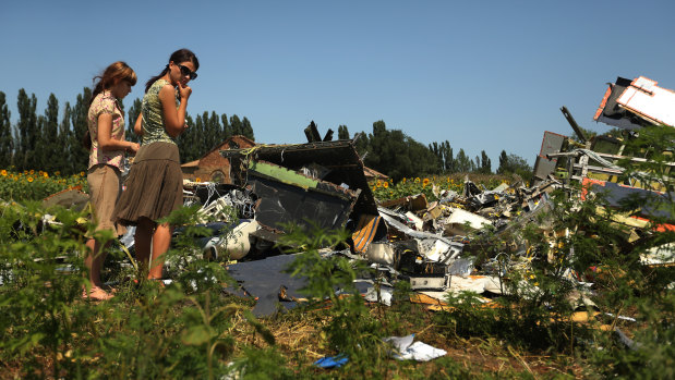 Women amid the debris of downed flight MH17 in East Ukraine.