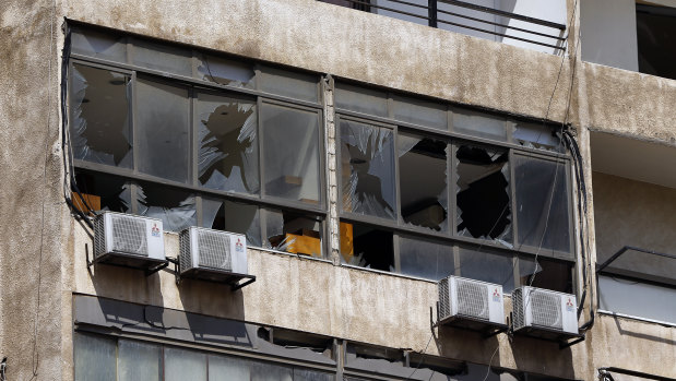 Broken windows are seen on the 11-floor building that houses the media office in a stronghold of the Lebanese Hezbollah group in a southern suburb of Beirut, Lebanon.
