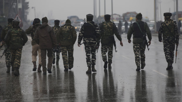 Indian paramilitary soldiers patrol near the site of an explosion in Pampore, Indian-controlled Kashmir.