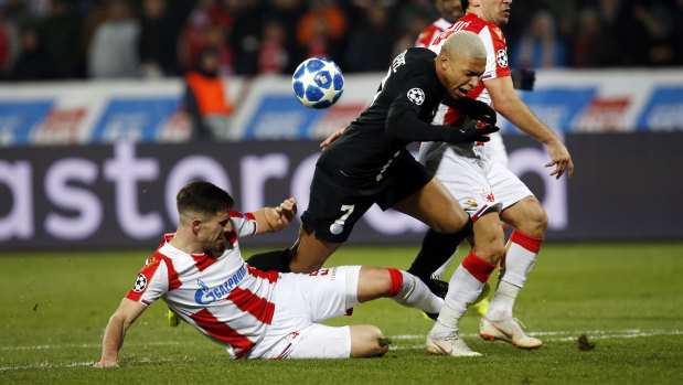 Big time player: Milos Degenek tackles French World Cup star Kylian Mbappe during Red Star Belgrade's UEFA Champions League clash with Paris Saint-Germain in December.