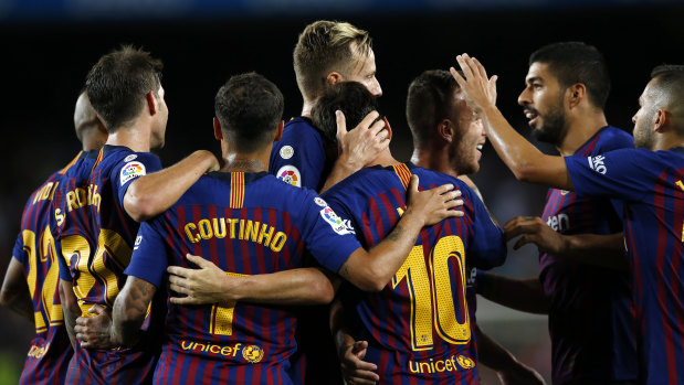 On song: Barcelona's Lionel Messi (No.10) celebrates with teammates after scoring against Alaves.