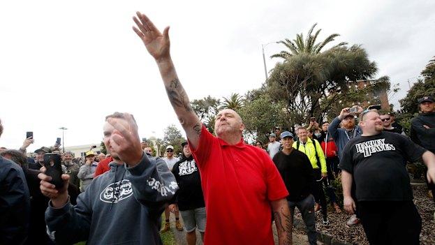 A protester issues a Nazi salute at rally in St Kilda.