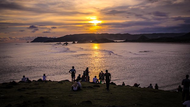 Tourists and locals gathering to watch the sunset on Bukit Merese Hill in Lombok's south.