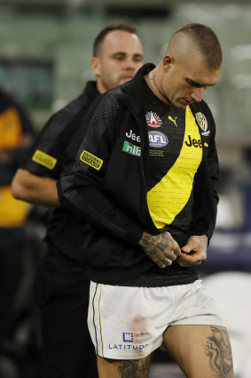Dustin Martin puts on a jacket after leaving the ground with concussion.