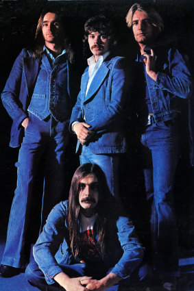 Alan Lancaster (centre standing) with Status Quo.