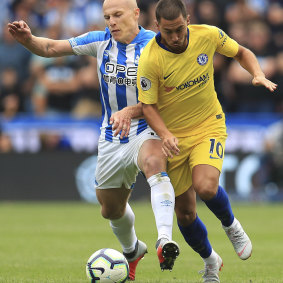 Huddersfield Town Socceroo Aaron Mooy, left, and Chelsea's Eden Hazard during their English Premier League  match at the John Smith's Stadium in Huddersfield on  Saturday. Chelsea won 3-0. 