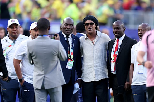 Ronaldinho poses for photos ahead of the match between Brazil and Haiti.