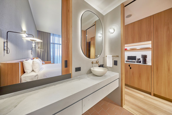 A sliding door separating the bathroom allows you to open the room up.