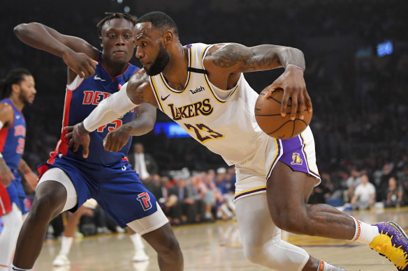 Lakers superstar LeBron James drives past Detroit Pistons forward Sekou Doumbouya.