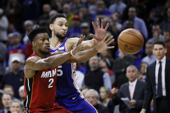 Ben Simmons reaches for the ball against former teammate Jimmy Butler, who received a hostile reception.