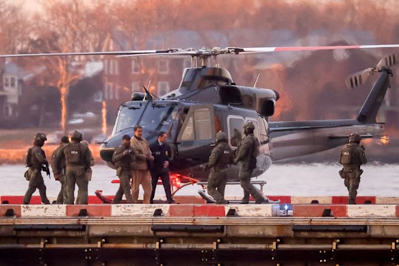 Nicolás Maduro and his wife, Cilia Flores (obscured) arrive at the heliport ahead of their transfer by vehicle to the courthouse.