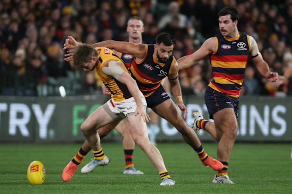 Dylan Moore of the Hawks is tackled by Wayne Milera of the Crows.
