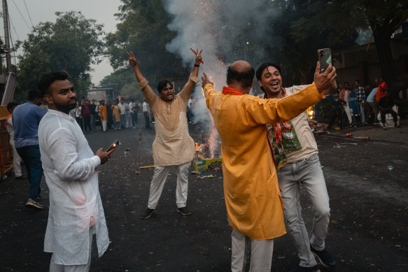 Supporters of Indian Prime Minister Narendra Modi celebrate in a New Delhi street.