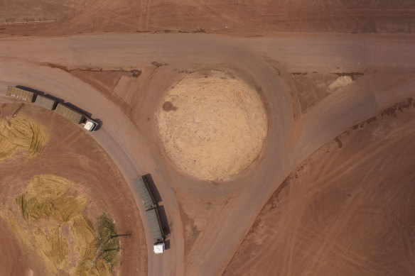 Cargo trucks turn off the Trans-Amazon highway, top, in Campo Verde, Para state, Brazil. Carved through jungle during Brazil’s military dictatorship in the 1970s, the roads were built to bend nature to man’s will in the vast hinterland. Five decades later, there’s worsening deforestation.