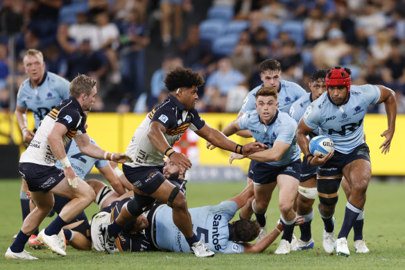 Langi Gleeson of the Waratahs runs  into contact