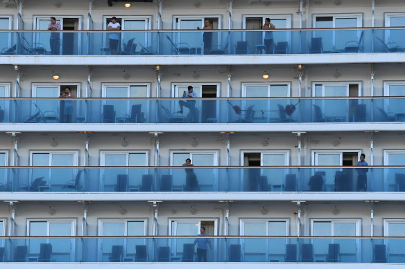 Crew on board the Ruby Princess as the cruise liner docks at Port Kembla on Monday