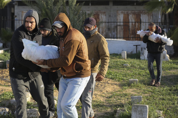 Palestinians carry the bodies of the Dhair family, killed in the Israeli bombardment of the Gaza Strip, during their funeral in Rafah on Friday.