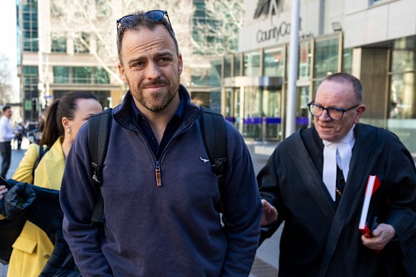Former police officer Thomas Horsburgh leaves the Melbourne County Court with his barrister.