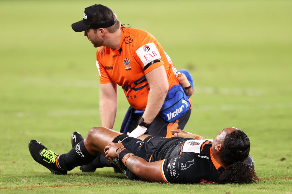 Luciano Leilua of the Tigers receives treatment after being hit with a cannonball tackle.