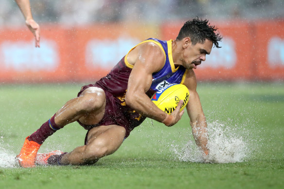 Charlie Cameron splashes after the ball as rain fell early on at the Gabba.

