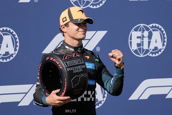 Lando Norris celebrates after securing pole position in qualifying.