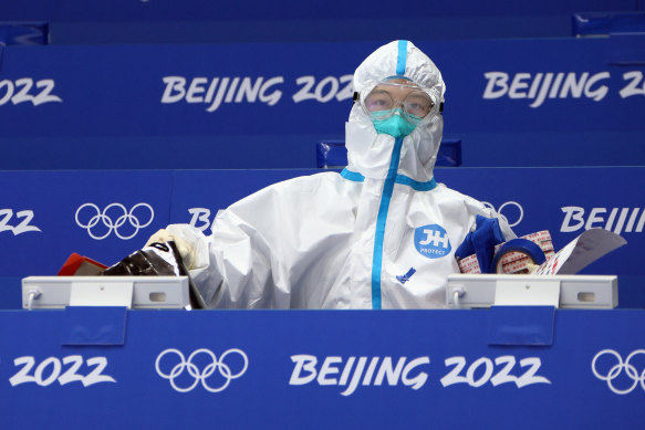 Arena workers in full PPE prepare for the start of the 2022 Beijing Winter Olympic Games on Friday.
