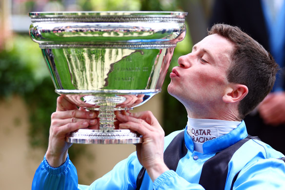 Jockey Oisin Murphy plants a kiss on the silverware after riding Asfoora to victory in the King Charles III Stakes at Royal Ascot.