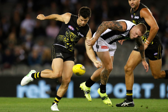 Richmond’s Trent Cotchin and Magpie Jordan De Goey go head to head.