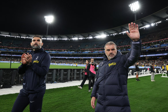 Tottenham Hotspur coach Ange Postecoglou, right, and former Socceroos captain Mile Jedinak thanks fans at the MCG on Wednesday night.