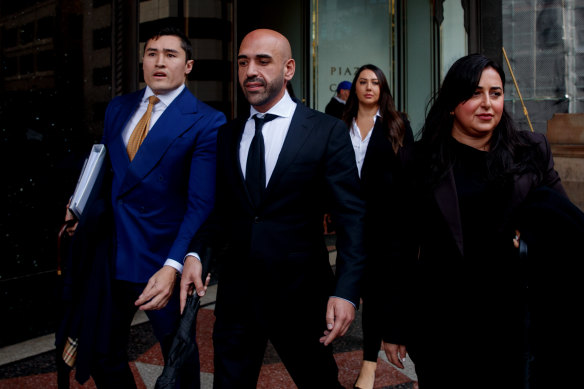 Tamer Uzun (centre) leaves the Downing Centre District court on Friday.