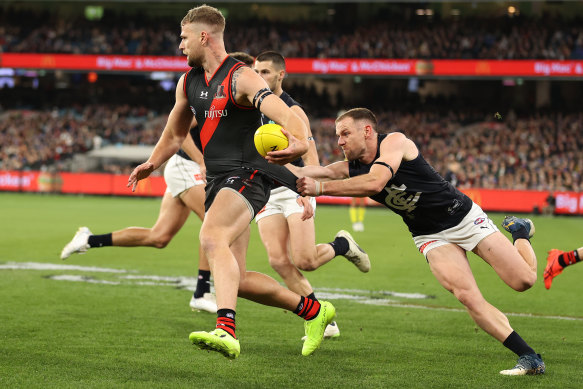 Jake Stringer of the Bombers is challenged by Blues veteran Sam Docherty.