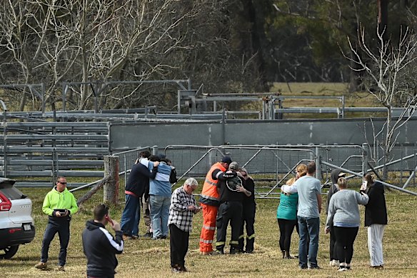 Family and friends console one another on hearing the news that the body of missing bushwalker Lily Hooper had been found.