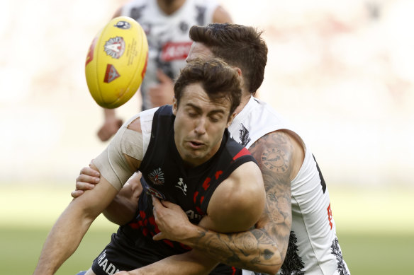 Jack Crisp of the Magpies tackles Andrew McGrath.