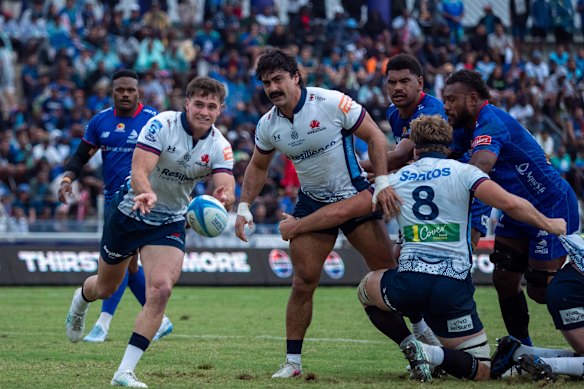 Teddy Wilson of the Waratahs passing the ball in Fiji against the Drua