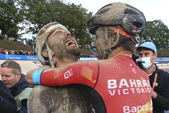 Australian Heinrich Haussler hugs teammate Sonny Colbrelli at the finish. 