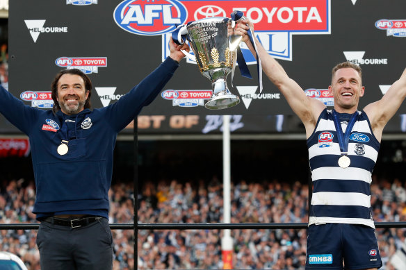 Chris Scott and Joel Selwood hold up the 2022 AFL premiership cup.