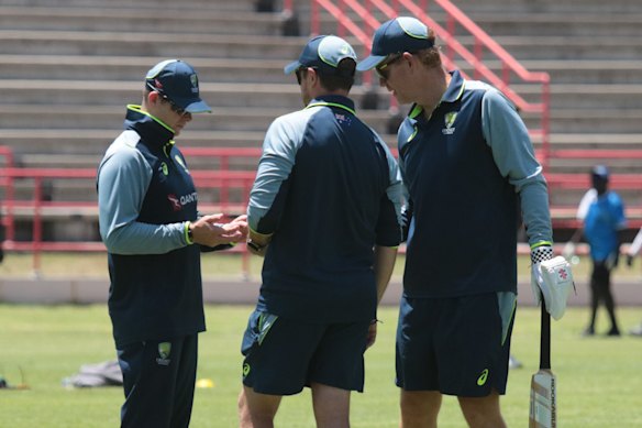 Smith (left) chats with Australia’s physiotherapist Nick Jones and head coach Andrew McDonald on Tuesday. 